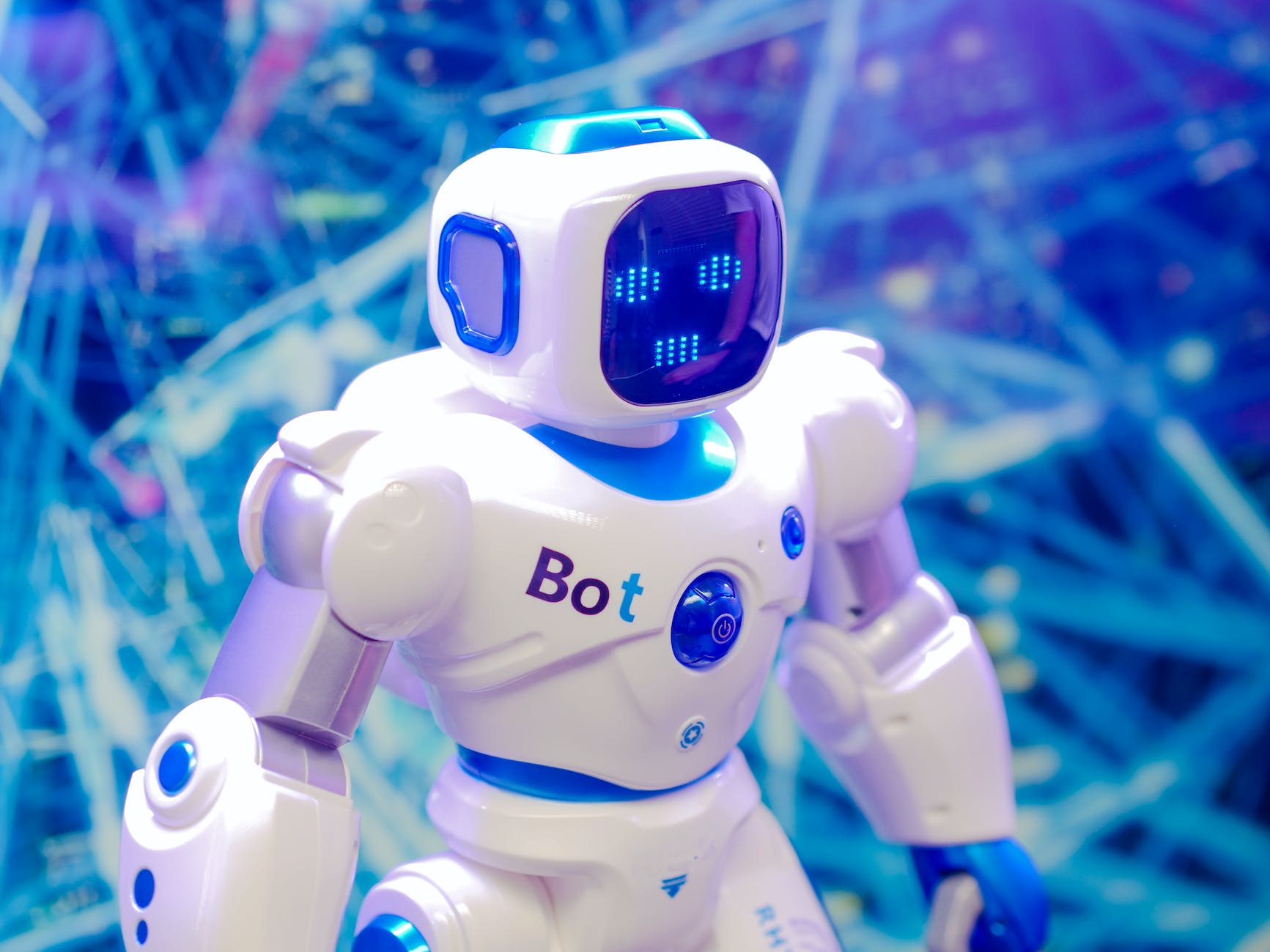 Photo by Kindel Media on <a href="https://www.pexels.com/photo/white-and-blue-robot-toy-on-blue-string-lights-8566467/" rel="nofollow">Pexels.com</a>